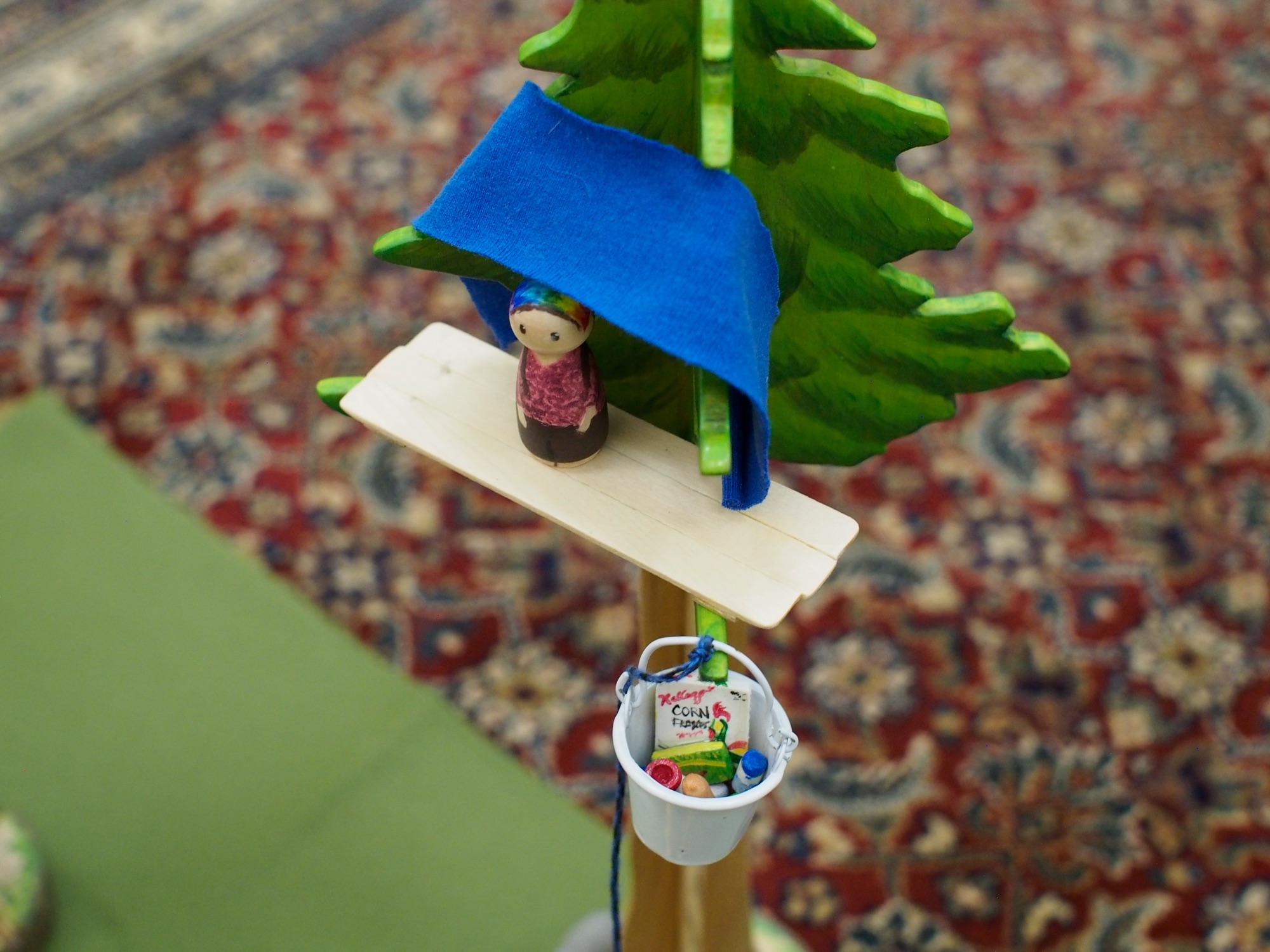A handmade Montessori Story Basket with its figures and cards in natural wood